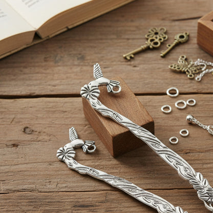 Hackberry Creek antique silver zinc alloy hummingbird and flower metal bookmark blanks on a wooden craft table