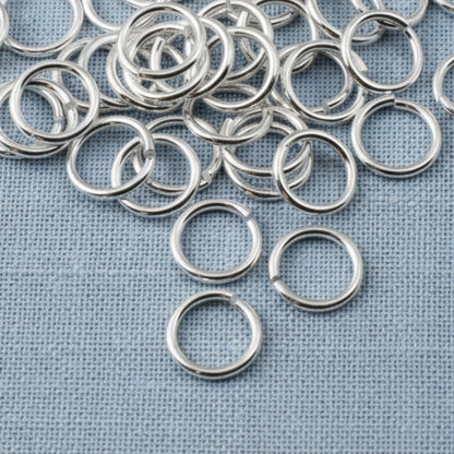 Hackberry Creek 8mm silver-plated brass jump rings for jewelry making, featuring a bright polished finish.