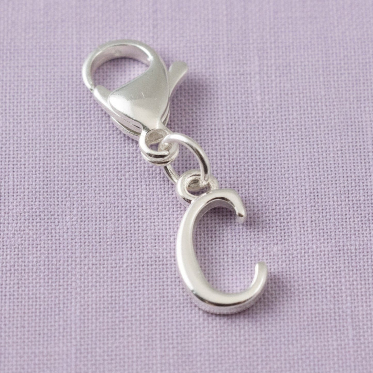 Hackberry Creek silver cursive letter C charm with a stainless steel lobster clasp for journals and bracelets.
