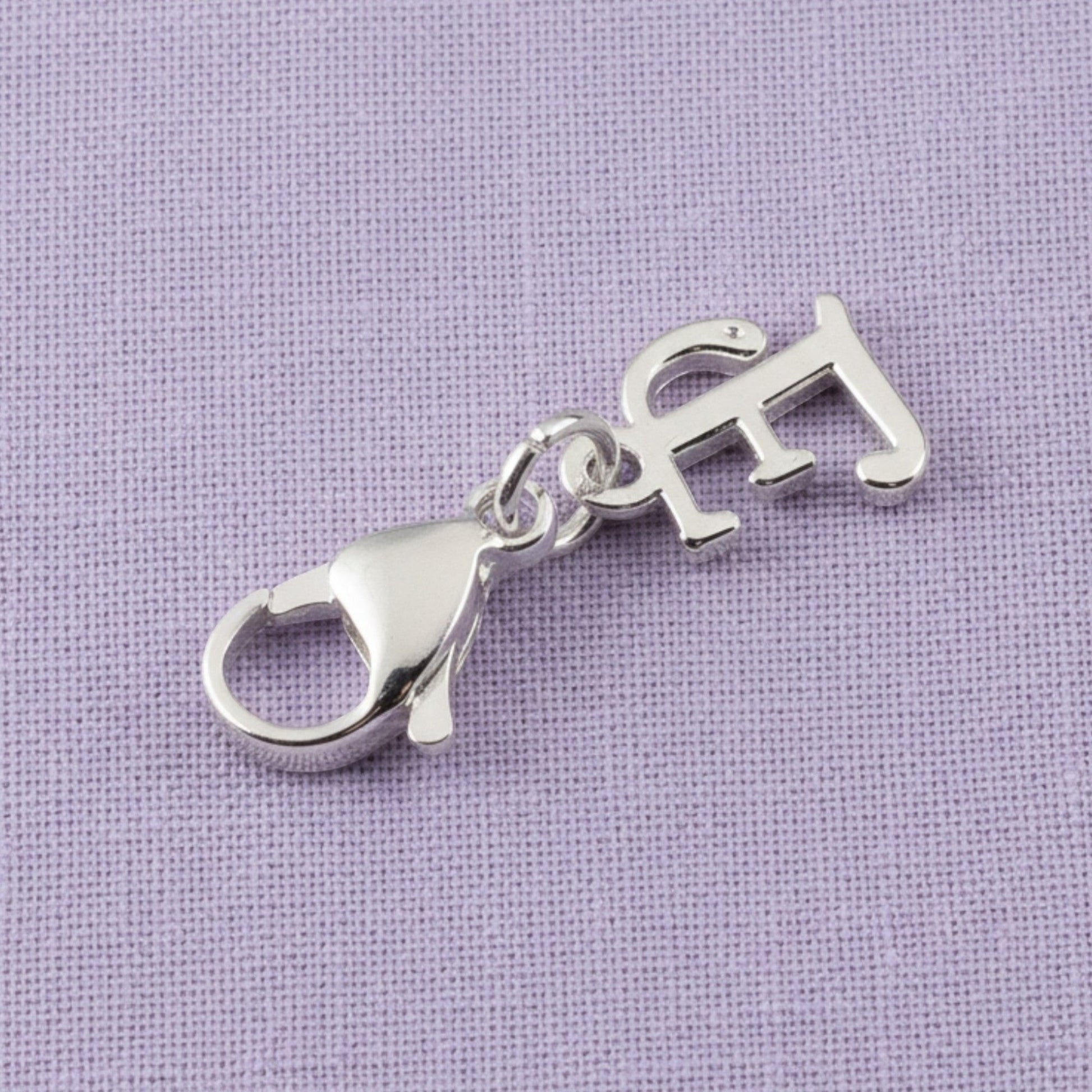 Hackberry Creek silver cursive letter E charm with a stainless steel lobster clasp for journals and bracelets.