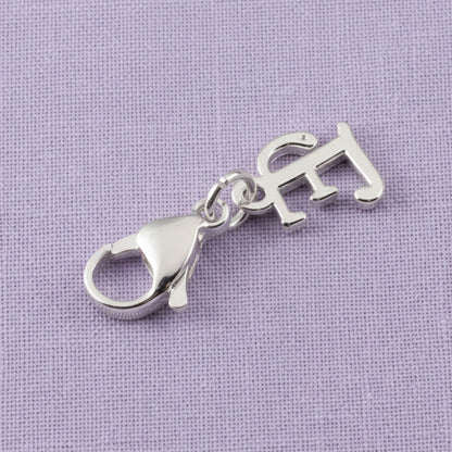 Hackberry Creek silver cursive letter E charm with a stainless steel lobster clasp for journals and bracelets.