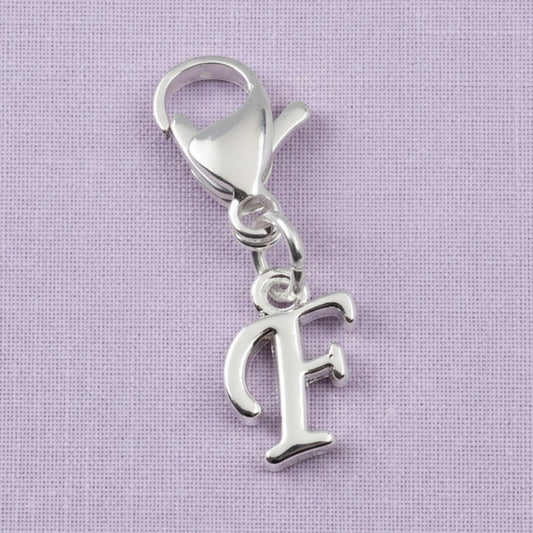 Hackberry Creek silver cursive letter F charm with a stainless steel lobster clasp for journals or bracelets.