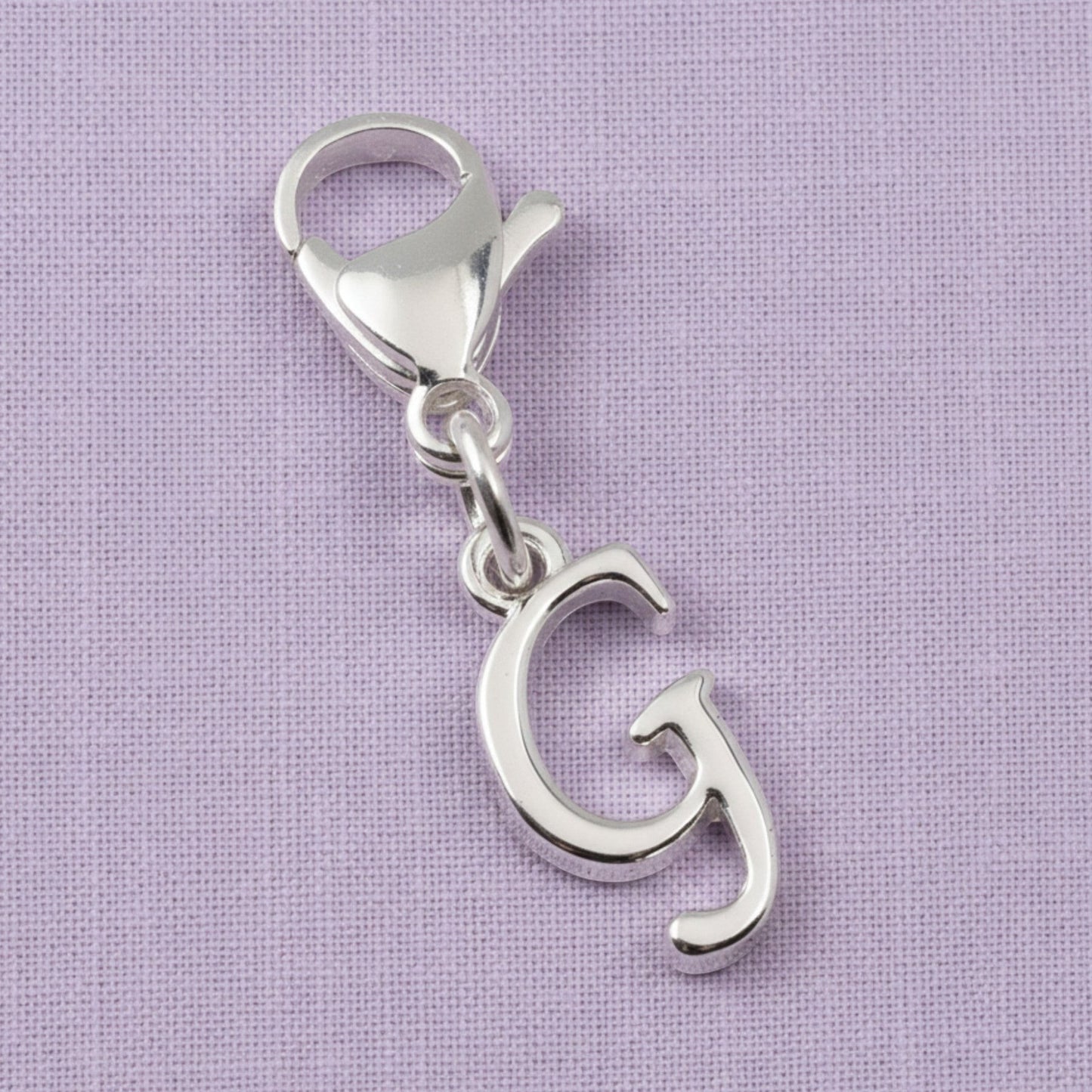 Hackberry Creek silver cursive letter G charm with a stainless steel lobster clasp for journals or bracelets.