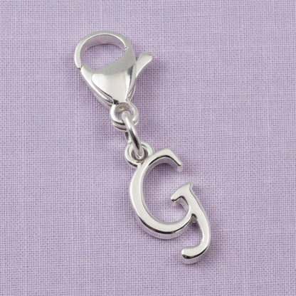 Hackberry Creek silver cursive letter G charm with a stainless steel lobster clasp for journals or bracelets.