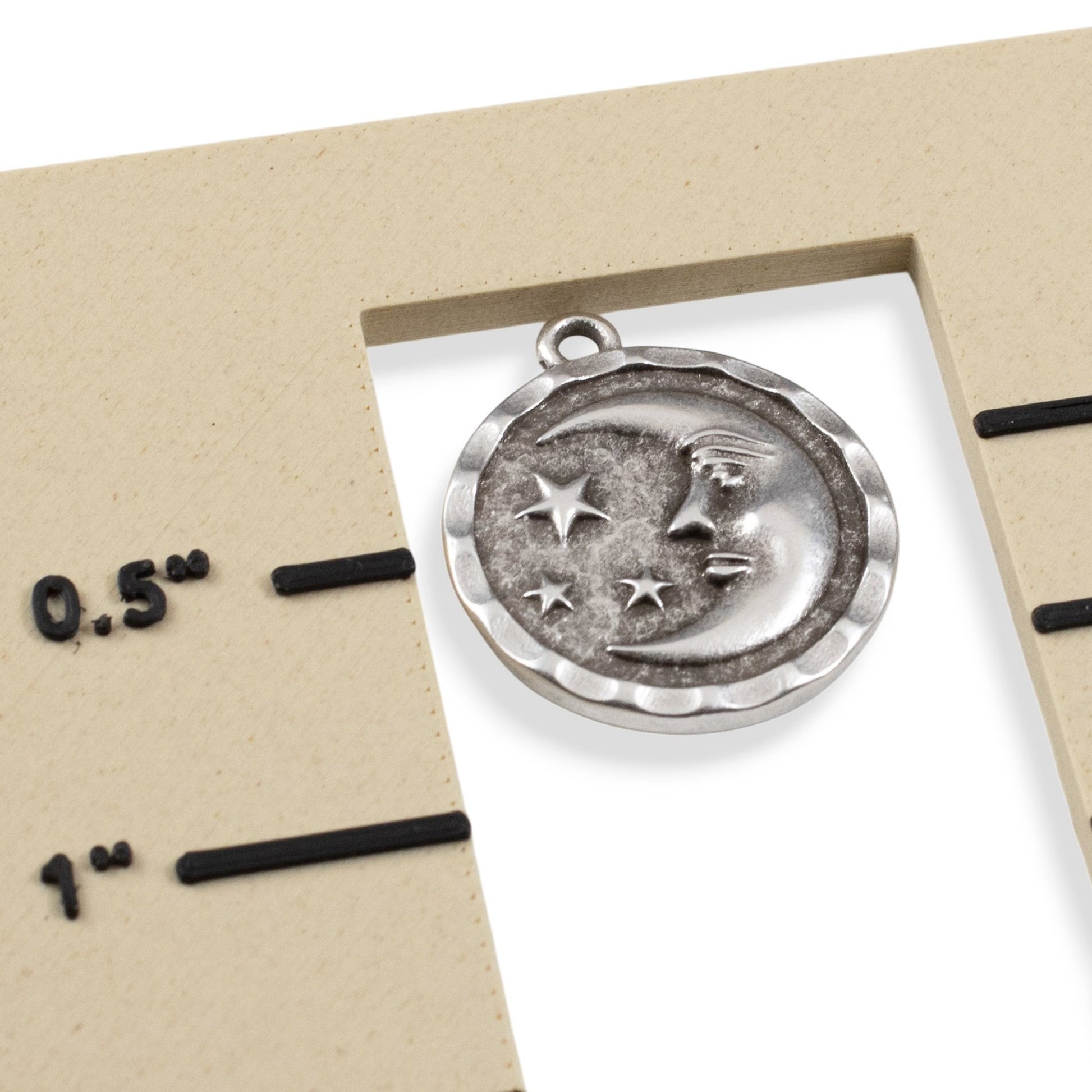 Hackberry Creek antique silver celestial pendant showing a crescent moon and stars on a measurement scale.