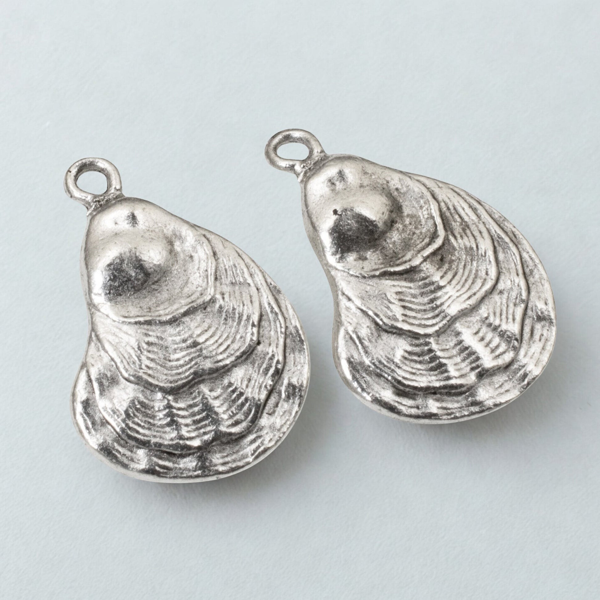 Hackberry Creek silver oyster shell charms with antique finish for coastal jewelry making