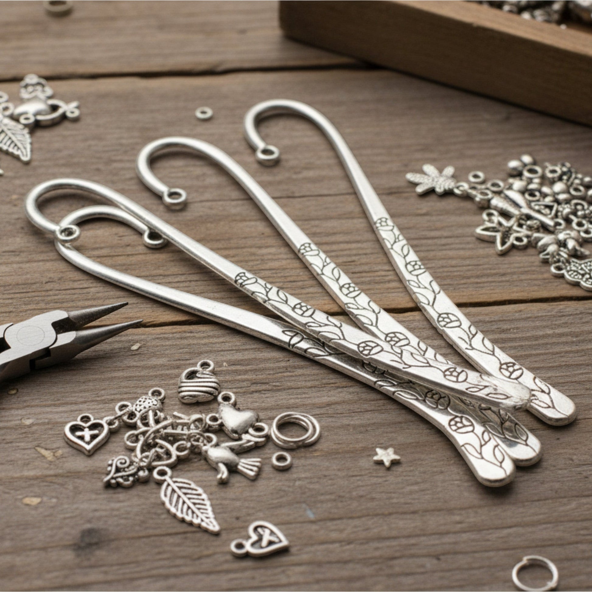 Hackberry Creek antique silver shepherd hook bookmarks with etched rose and vine patterns for DIY charm projects.
