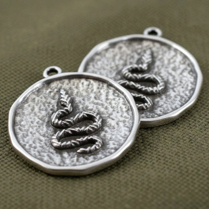 Hackberry Creek two silver plated hammered coin pendants with raised serpent relief, antique finish, boho charm.