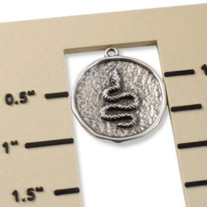 Hackberry Creek antique silver plated hammered coin pendant with raised serpent relief, 25x28mm. Boho charm.