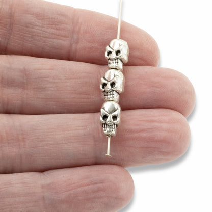 Hackberry Creek antique silver 3D skull alloy beads on a needle for jewelry making