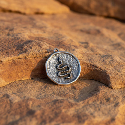 Hackberry Creek silver plated hammered coin pendant with raised serpent relief, antique finish, boho style.