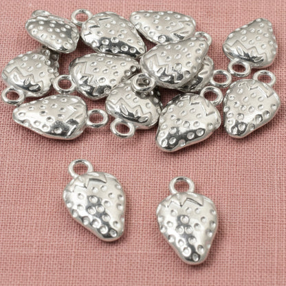 Hackberry Creek silver strawberry charms with textured detail and a hanging loop. Zinc alloy, 10mm x 17mm.