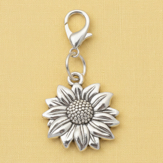 Hackberry Creek silver-plated sunflower clip-on charm for bags or journals with a detailed floral design.