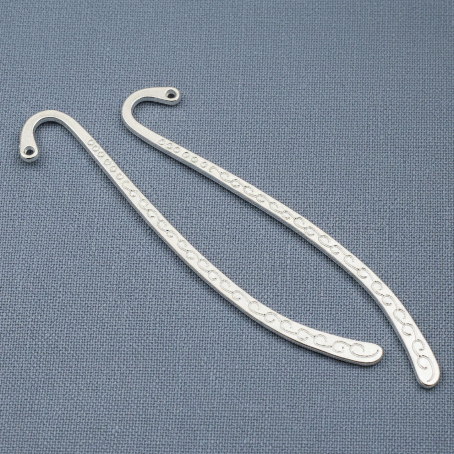 Hackberry Creek silver-tone zinc alloy hook bookmark blanks with decorative swirl patterns for DIY charm projects.