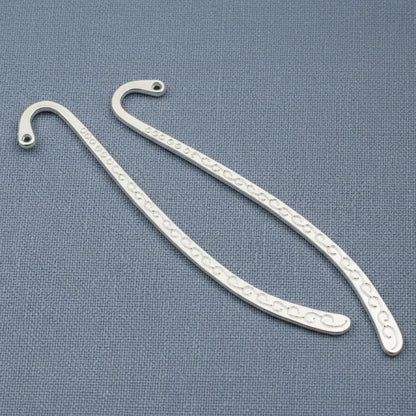 Hackberry Creek silver-tone zinc alloy hook bookmark blanks with decorative swirl patterns for DIY charm projects.