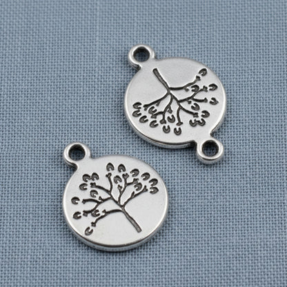 Hackberry Creek antique silver tree of life coin charms with detailed double-sided nature design for jewelry making.