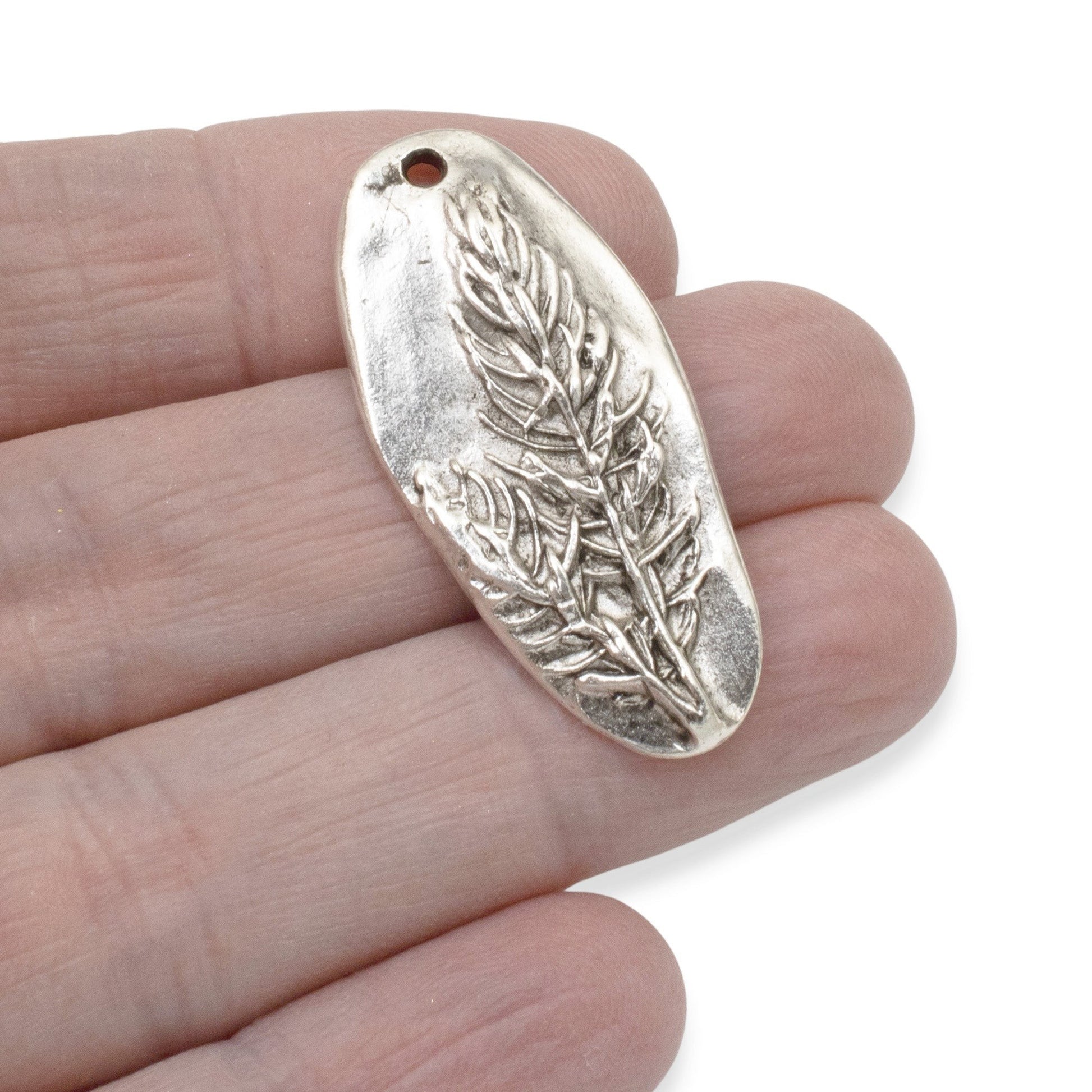 Hackberry Creek antique silver plated pewter oval pendant with a detailed tree design. Measures 40mm x 18.5mm.