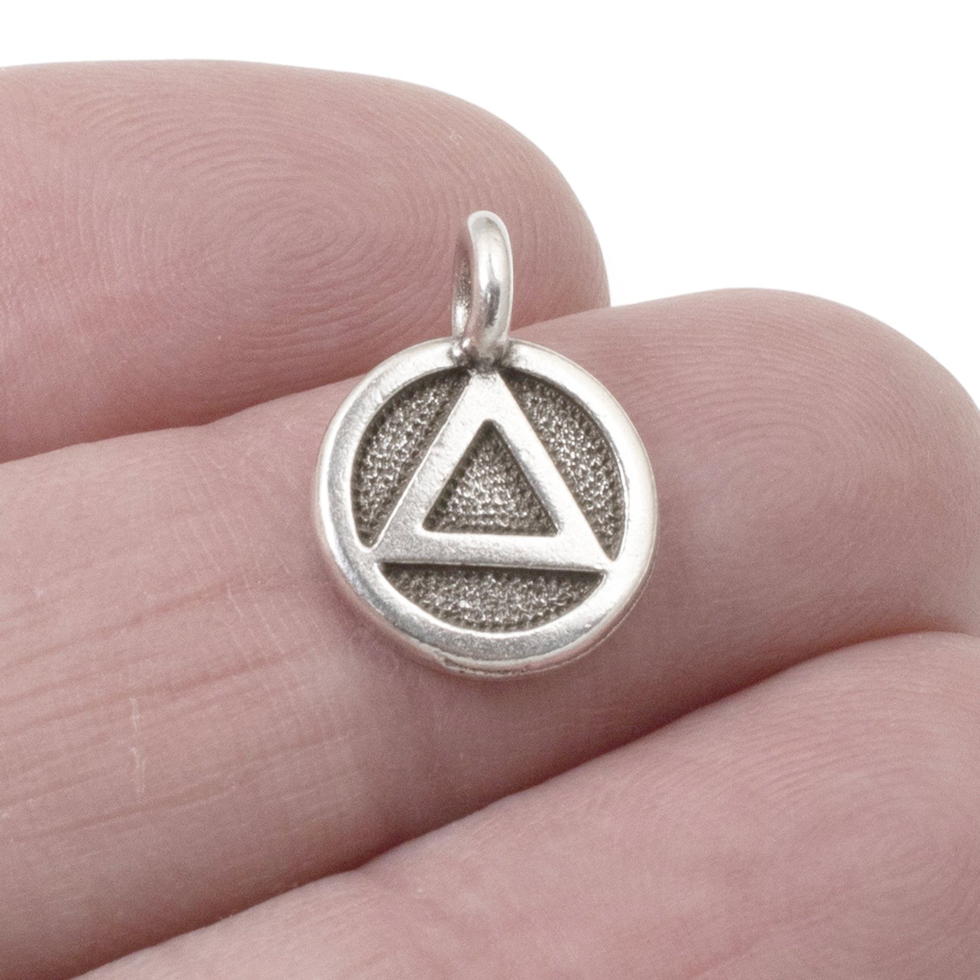 Hackberry Creek silver triangle recovery charm with sacred geometry symbol on textured background, 12mm x 16mm.