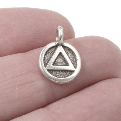 Hackberry Creek silver triangle recovery charm with sacred geometry symbol on textured background, 12mm x 16mm.