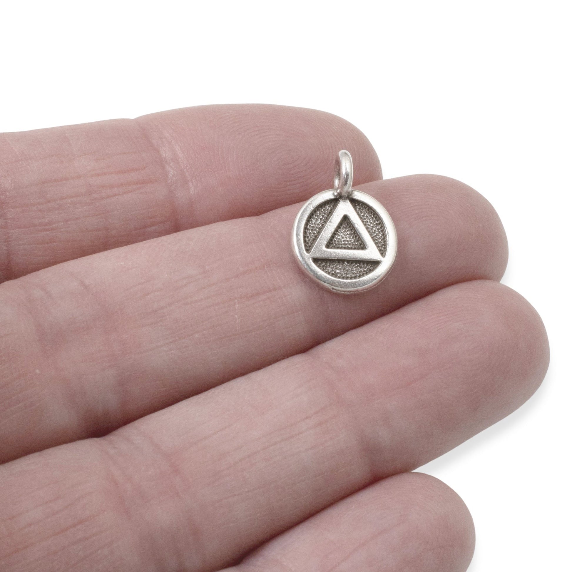 Hackberry Creek antique silver triangle recovery charm with sacred geometry symbol on a textured background, 12mm x 16mm.