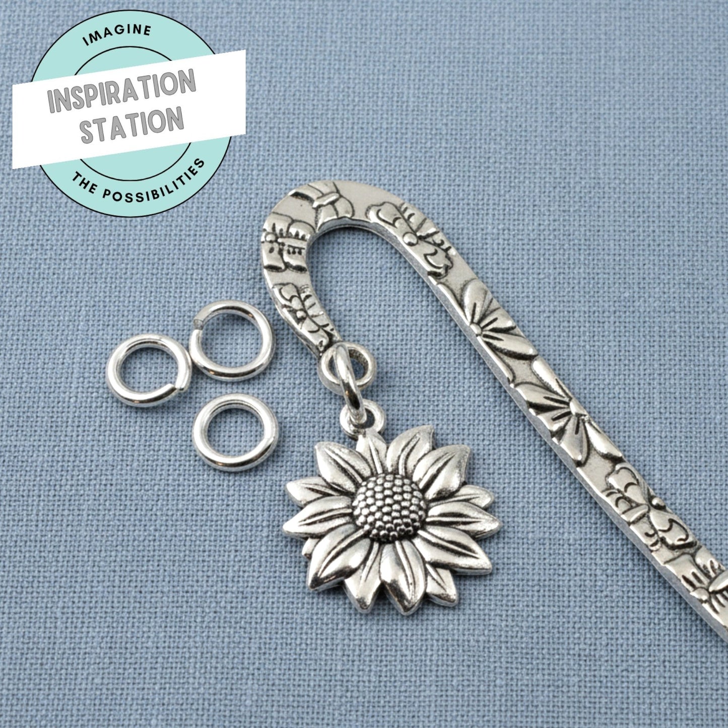 Hackberry Creek bright silver 304 stainless steel 8mm jump rings attached to a decorative sunflower metal bookmark.
