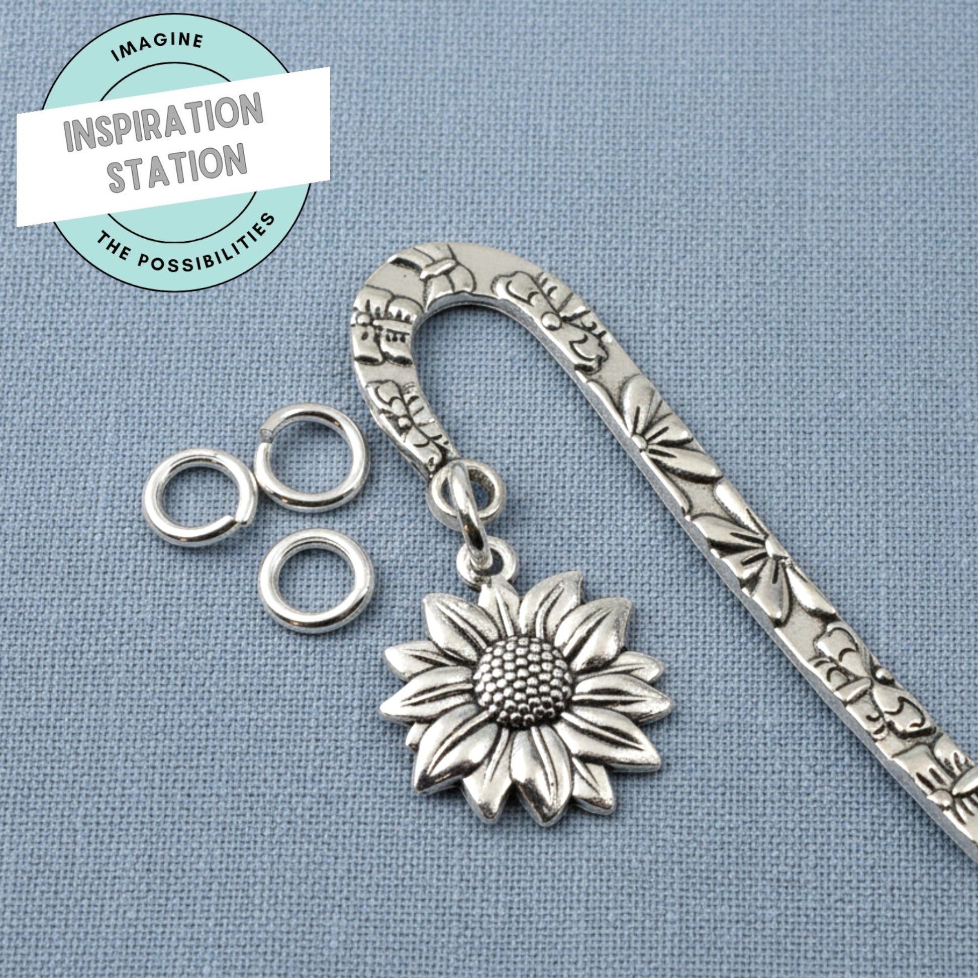 Hackberry Creek bright silver 304 stainless steel 8mm jump rings attached to a decorative sunflower metal bookmark.