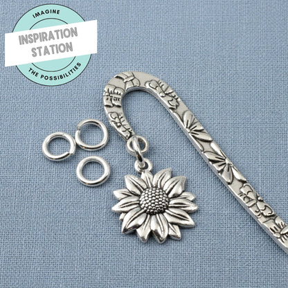 Hackberry Creek bright silver 304 stainless steel 8mm jump rings attached to a decorative sunflower metal bookmark.