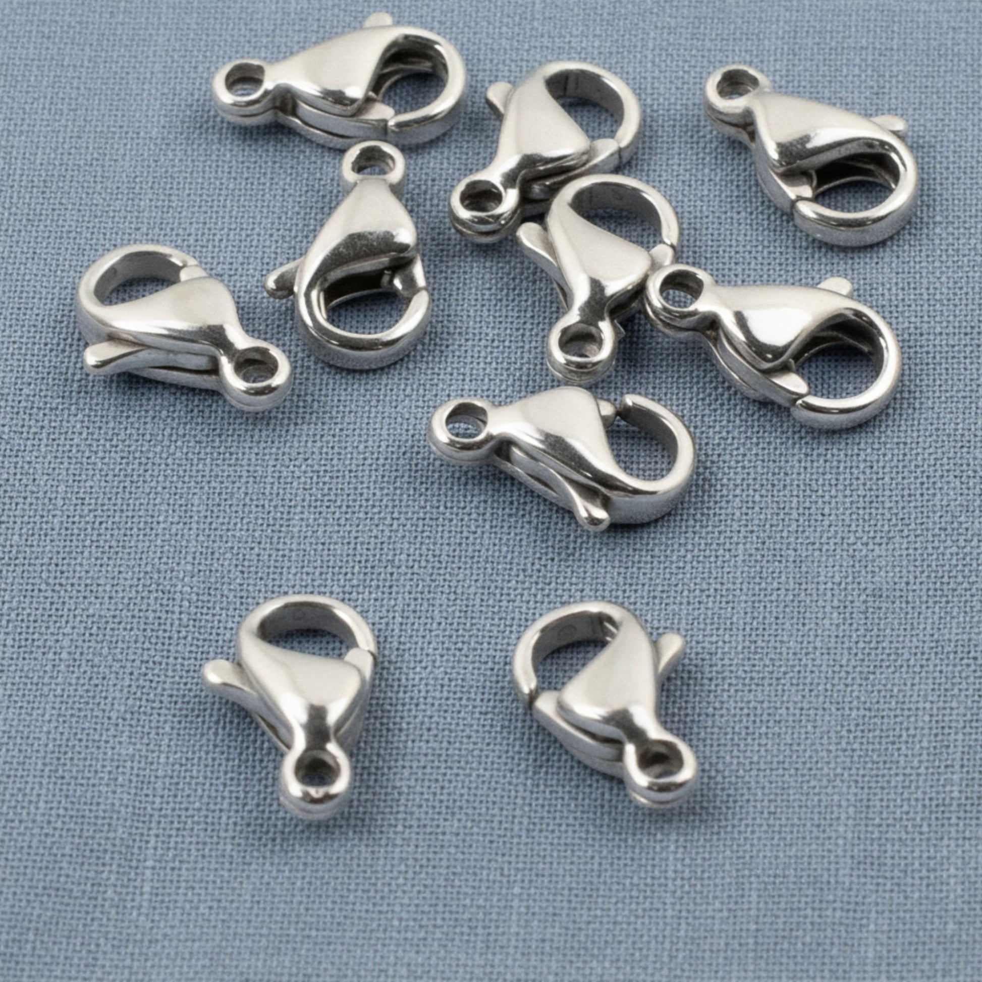Hackberry Creek set of 10 small dark silver stainless steel lobster claw clasps for minimalist jewelry making.