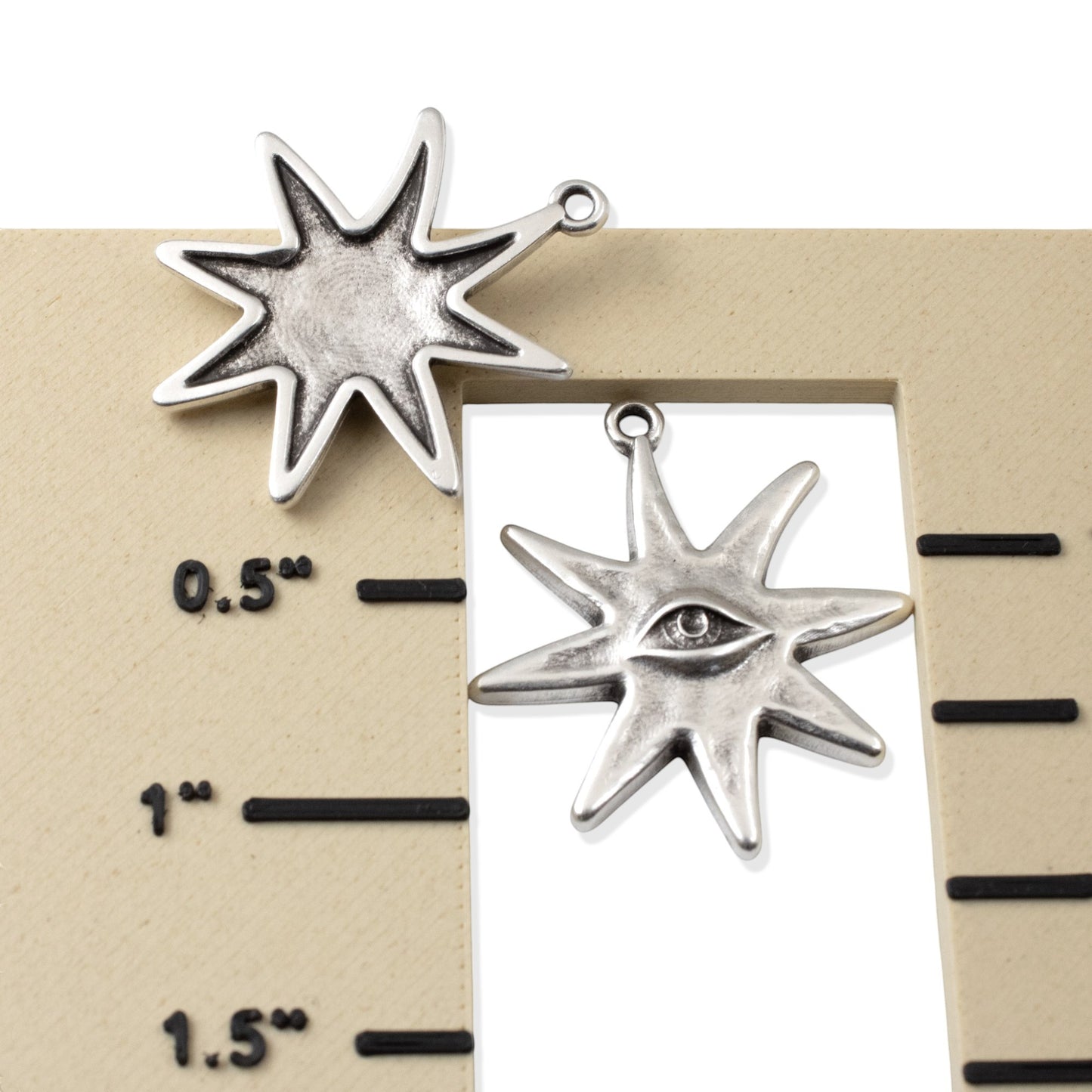 Hackberry Creek silver star eye pendants showing front and back detail on a measurement scale for jewelry making.