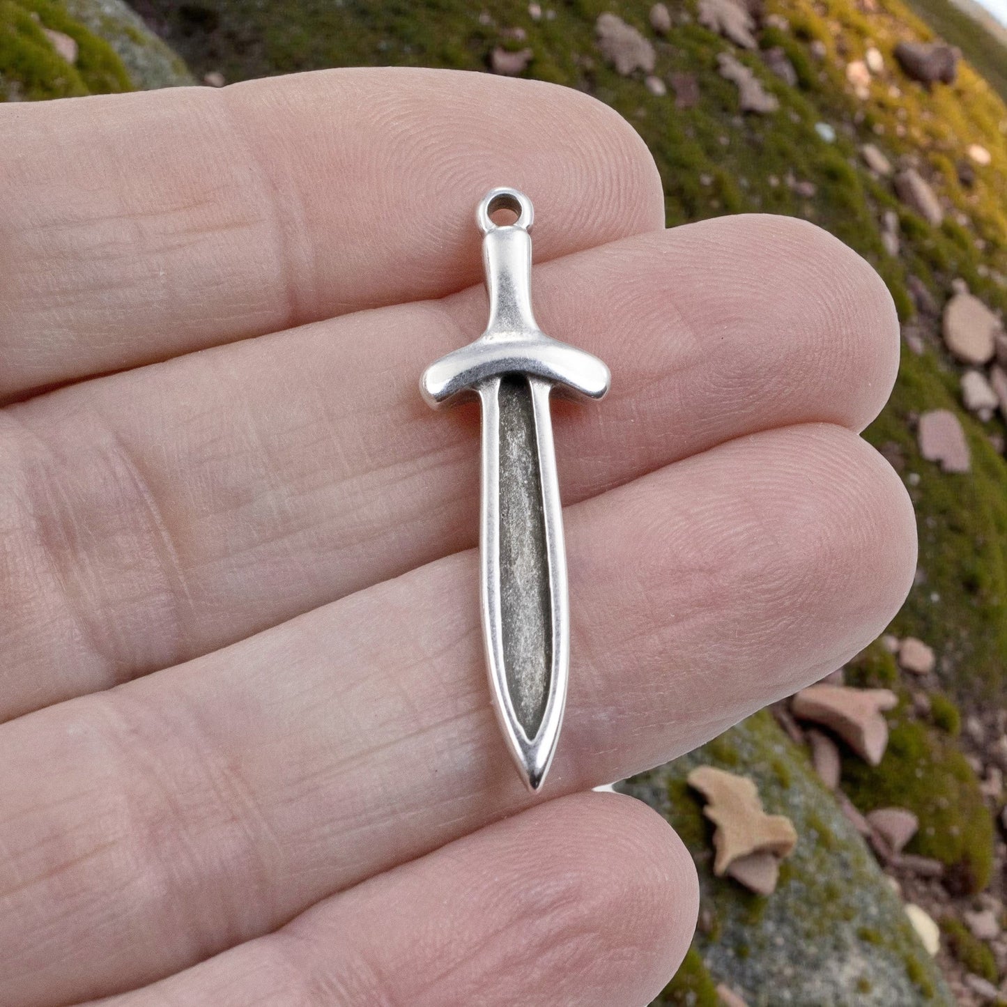 Hackberry Creek antique silver plated Zamak sword dagger charm with recessed front, 11.5mm x 38.5mm.
