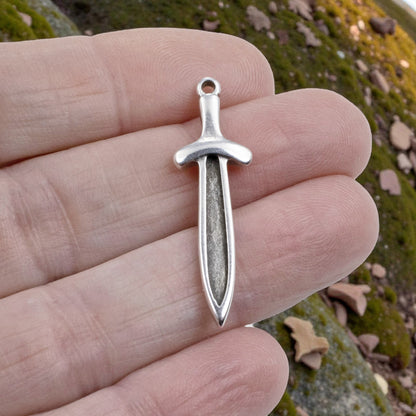 Hackberry Creek antique silver plated Zamak sword dagger charm with recessed front, 11.5mm x 38.5mm.