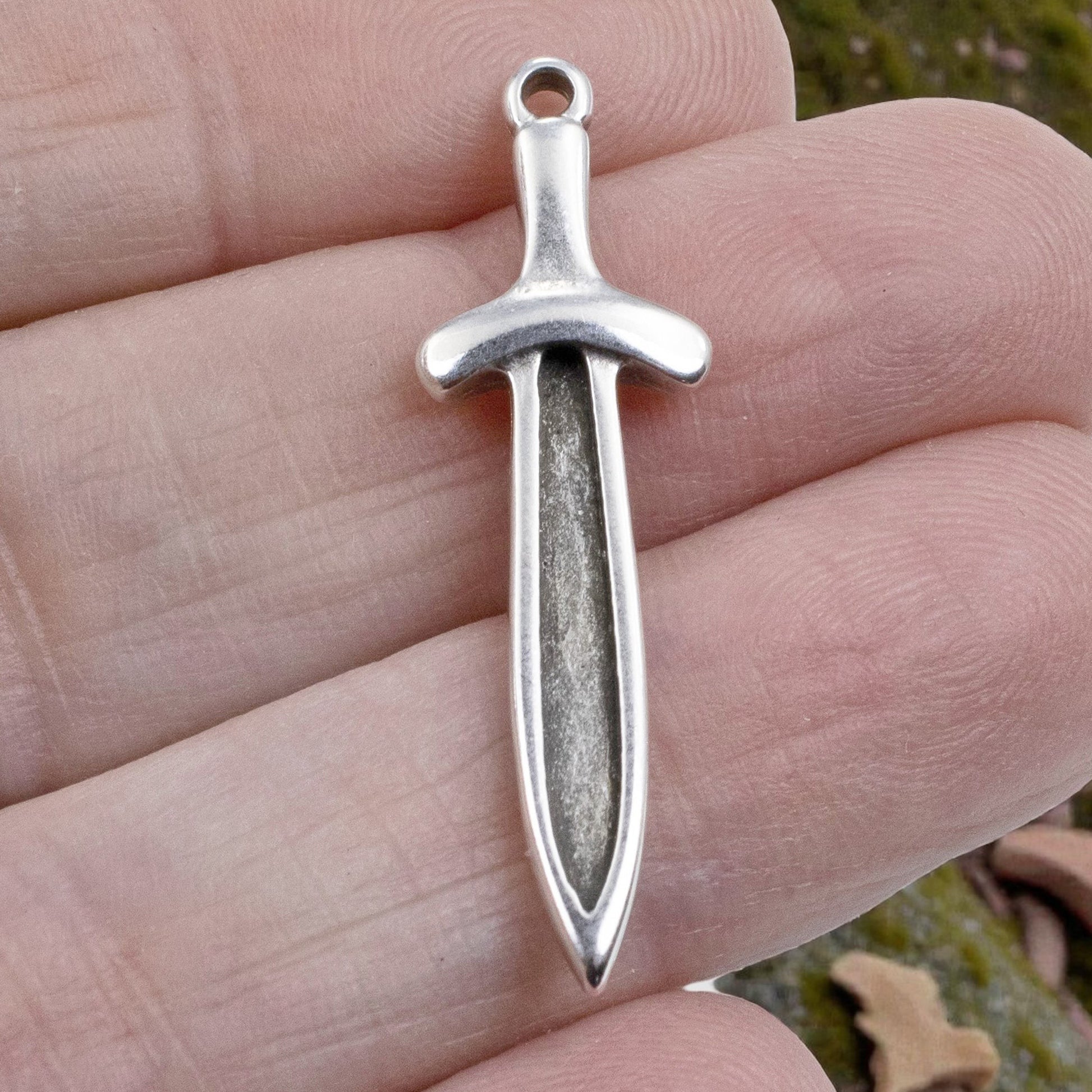Hackberry Creek antique silver plated Zamak sword dagger charm, 11.5mm x 38.5mm, double-sided with recessed front for enamel.
