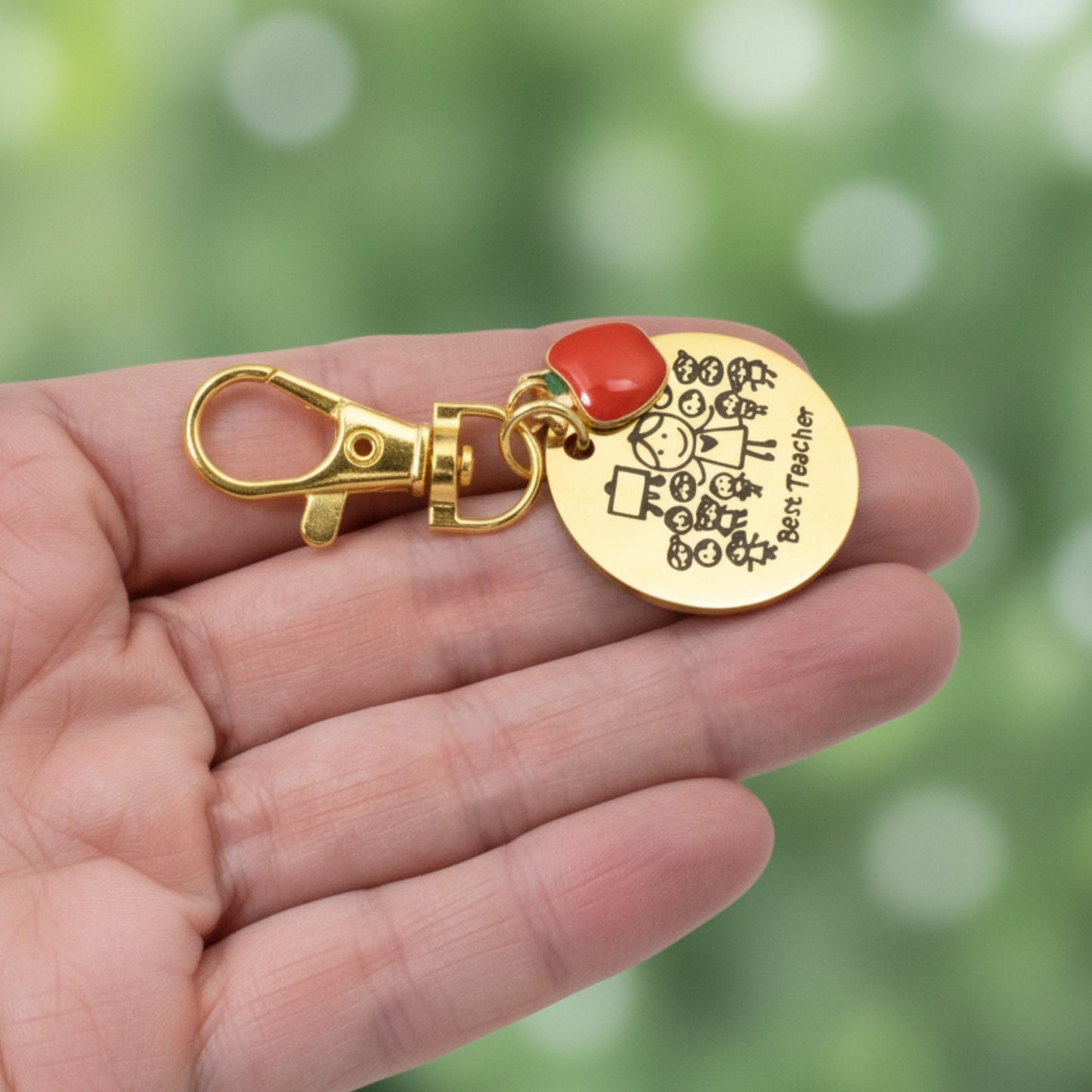 Hackberry Creek gold stainless steel Best Teacher bag charm with red enamel apple and engraved student illustration