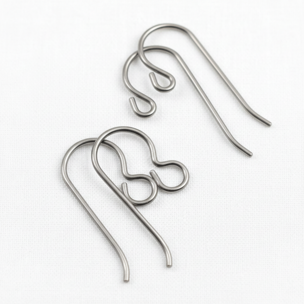 Hackberry Creek titanium earring hook starter set featuring regular and front loop styles in natural steel-gray finish.