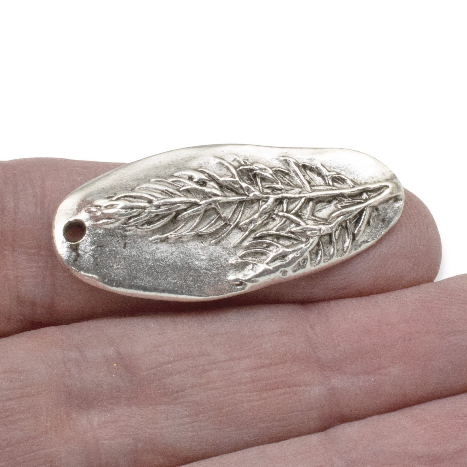 Hackberry Creek antique silver plated pewter oval pendant with a detailed tree branch design.