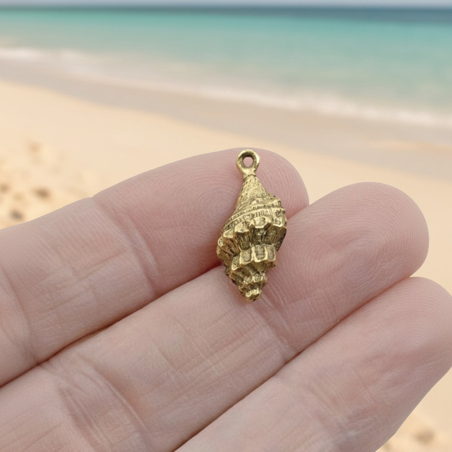Hackberry Creek 24K gold plated pewter trumpet shell charm with intricate detailing and antique finish.