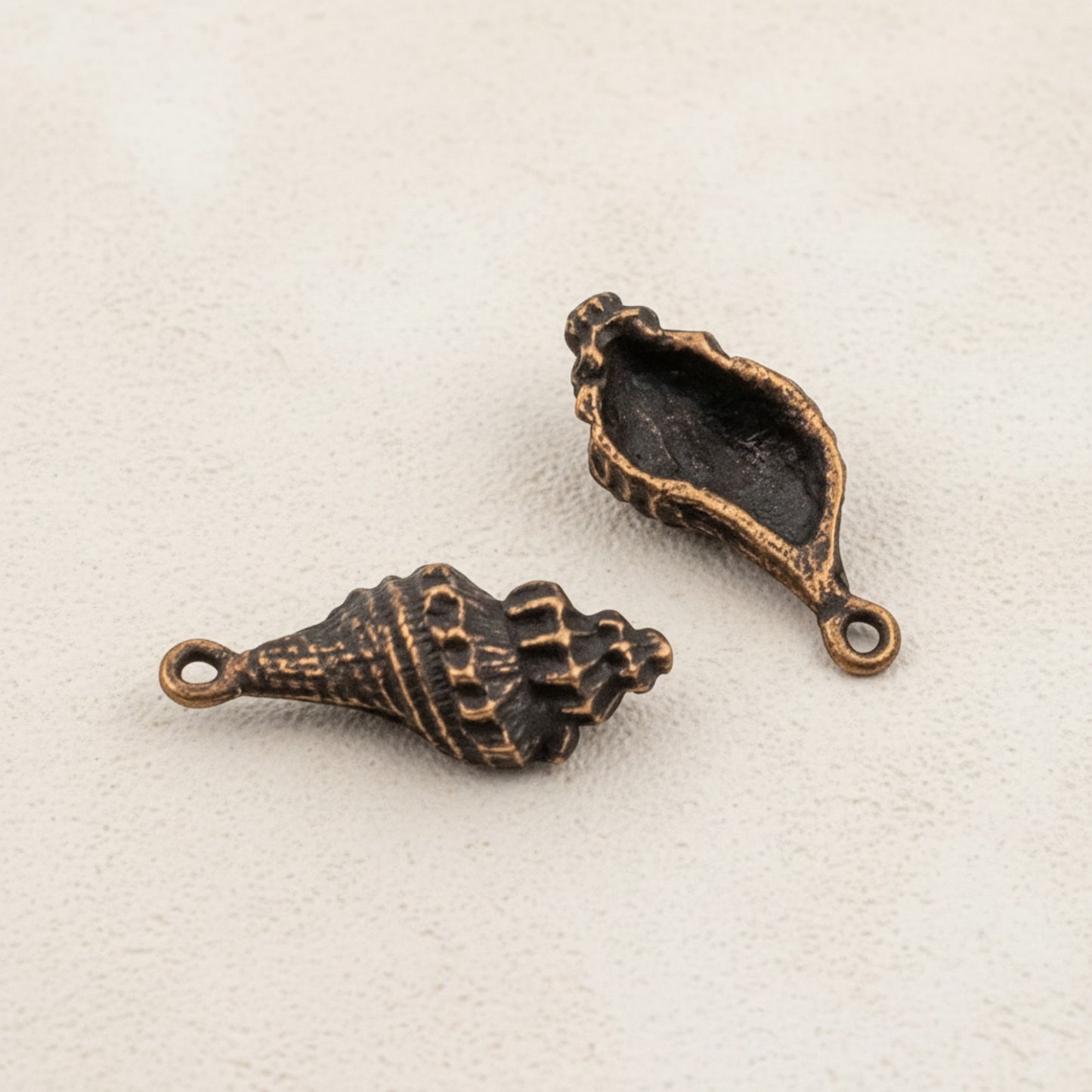 Hackberry Creek 2pcs copper plated pewter trumpet shell charms with intricate detailing, 21mm, for DIY beach nautical jewelry.