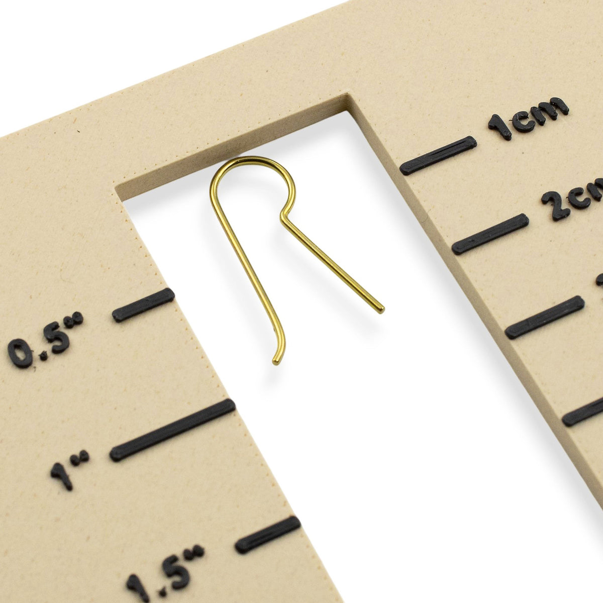Hackberry Creek yellow niobium earring hook blank on a measurement gauge for jewelry making