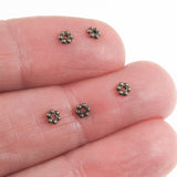 Brass Oxide 3mm Daisy Spacer Beads in hand